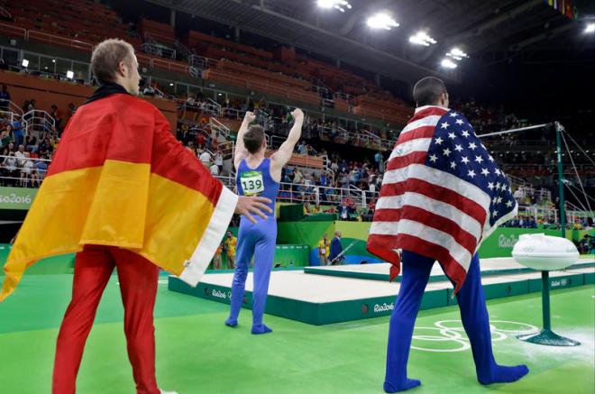 From left, gold medallist Germany's Fabian Hambuechen, bronze medallist Britain's Nile Wilson, and silver medallist United States' Danell Leyva celebrate during the medal ceremony for horizontal bar during the artistic gymnastics men's apparatus final at the 2016 Summer Olympics in Rio de Janeiro, Brazil, Tuesday, Aug. 16, 2016. (AP Photo/Rebecca Blackwell)